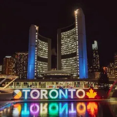 The illuminated TORONTO sign and City Hall at night